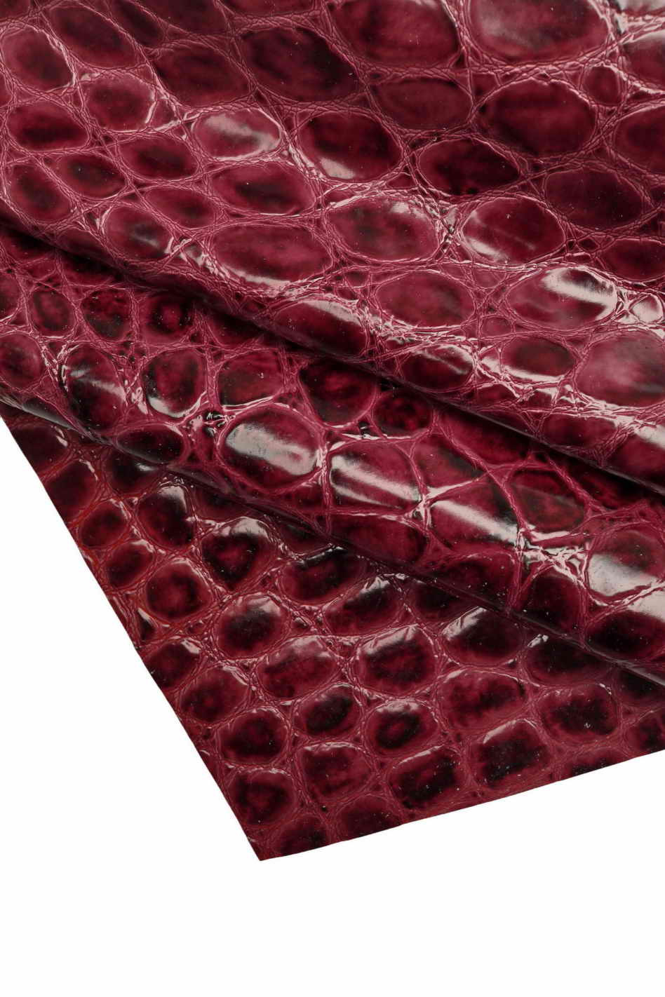 Dark crocodile skin texture in red color. Red reptile leather imitation  texture to background. Stock Photo