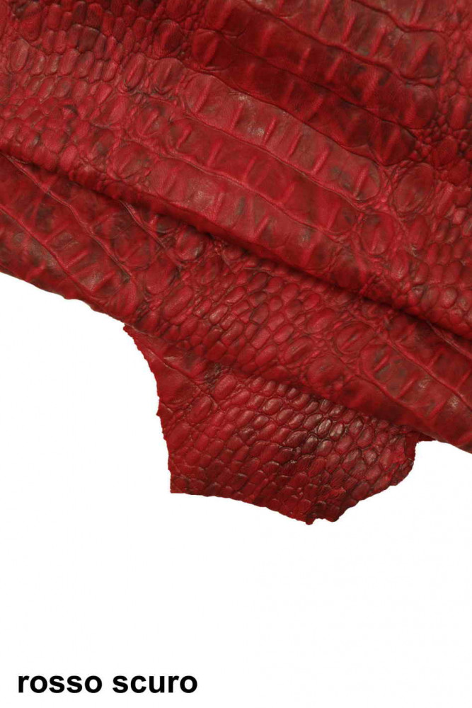 Dark crocodile skin texture in red color. Red reptile leather imitation  texture to background. Stock Photo